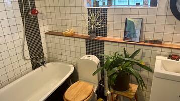 Bathtub, towels, soap, toilet paper