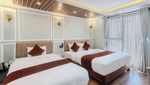 A hotel room with two beds, a wooden ceiling, and a large window with curtains. - Hotel Airport Deepshree (Kathmandu)