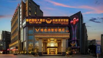 A hotel with a prominent sign, a large entrance, and a modern design.