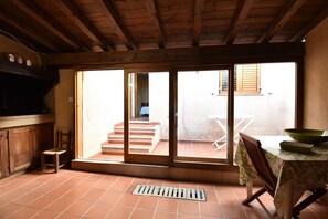 Relax in this serene room with a sliding door leading to an outdoor area and a comfortable chair.