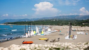 A beach with multiple sailboats and yachts docked along the shore. - Andriake Beach Club Hotel - All Inclusive  (Demre)