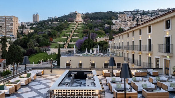 A rooftop terrace with outdoor seating, a bar area, and a view of the cityscape in the background. - Hotel Botanica- Limited Edition By Fattal (Haifa)