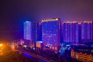 A nighttime view of a cityscape with illuminated high-rise buildings. - Lanting Wanpan Hotel (Changsha)