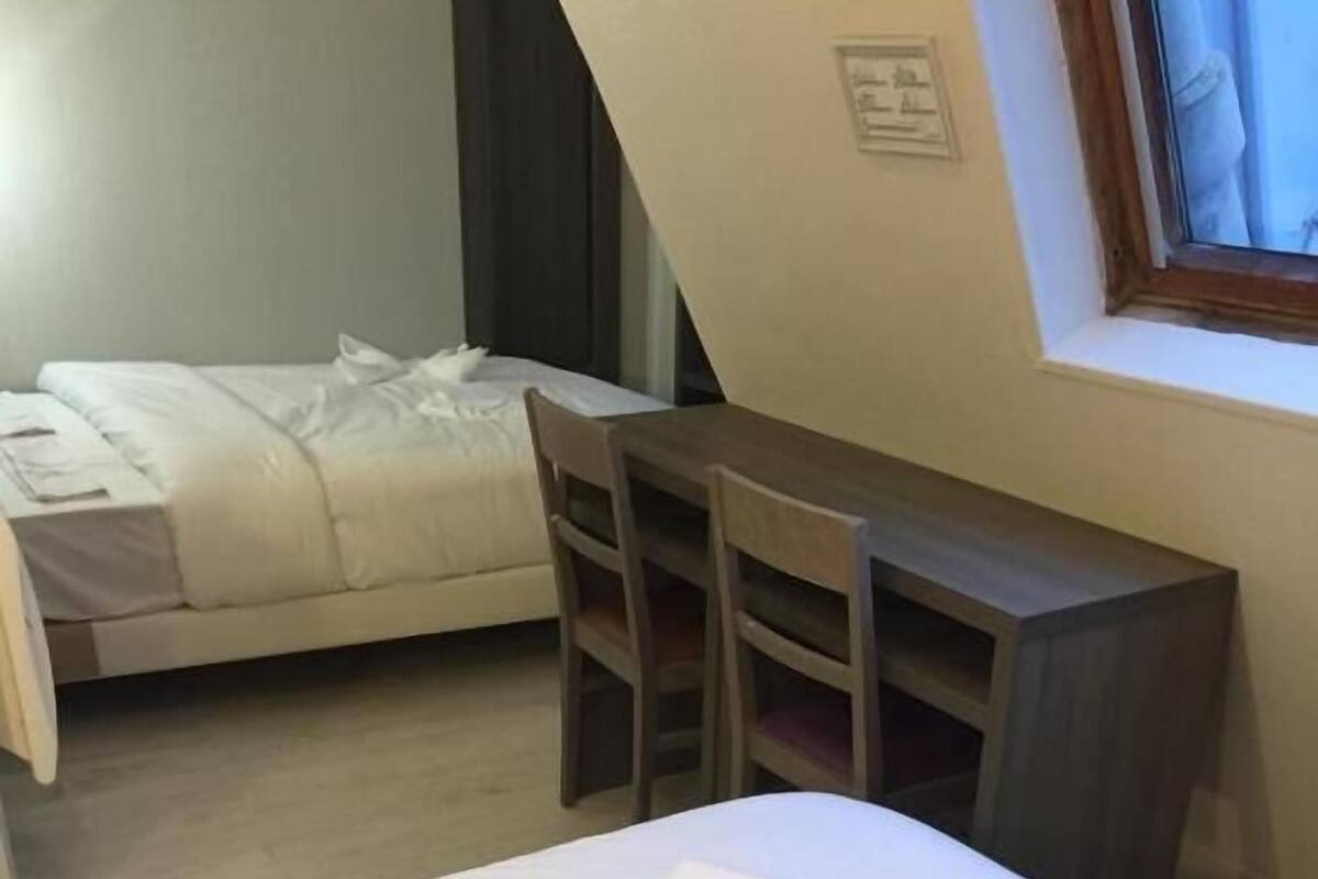 Ein Schlafzimmer mit einem Bett, einem Schreibtisch und einem Stuhl.