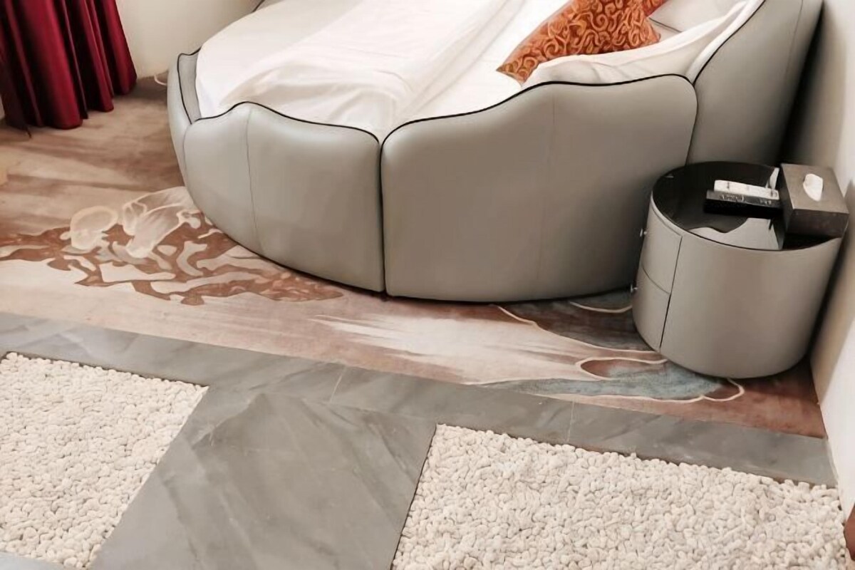 Un soggiorno moderno con un divano grigio, un tavolino e un tappeto decorato.