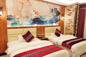 A hotel room with two beds, a large floral artwork on the wall, and a brick accent wall. - Shengcheng Jiayuan Hotel (Leishan)