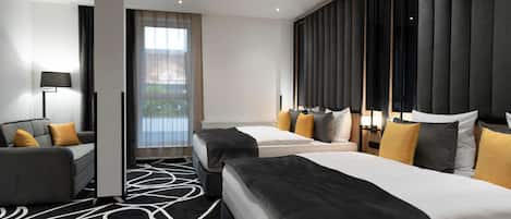 A hotel room with two beds, a sofa, a large window, and a modern design.