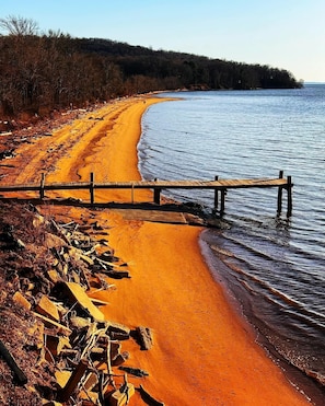 Walk along the beach to the shore, where a wooden walkway meets the sand.