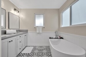 Bathtub, hair dryer, towels, soap