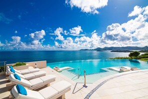 A poolside area with lounge chairs and a view of the sea. - Mes Amis (7/13 Rooms) (Les Terres Basses)