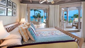 A bedroom with a bed, pillows, and a view of the beach and ocean. - Reeds House Penthouse 14 (2/3 Rooms) (Lower Carlton)