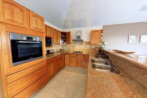 Enjoy cooking in this well-equipped kitchen with a Bosch oven, microwave, toaster, and sink.