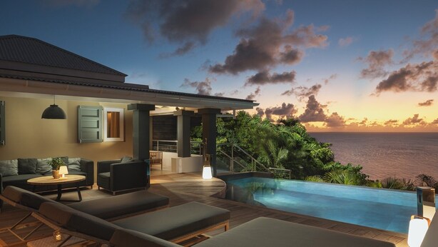 A modern outdoor living area with a pool, lounge chairs, and a view of the ocean at sunset. - Vague Bleue Luxury villa (Lurin)