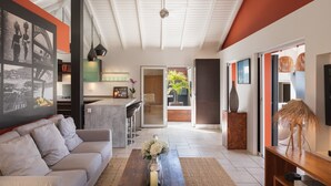 A modern living room with a sofa, coffee table, and artwork on the wall. - Vague Bleue Luxury villa (Lurin)