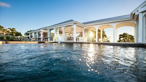 A poolside area with a covered seating area and a clear view of the pool. - Byzance (1/2 Rooms) Luxury villa (St Barts)