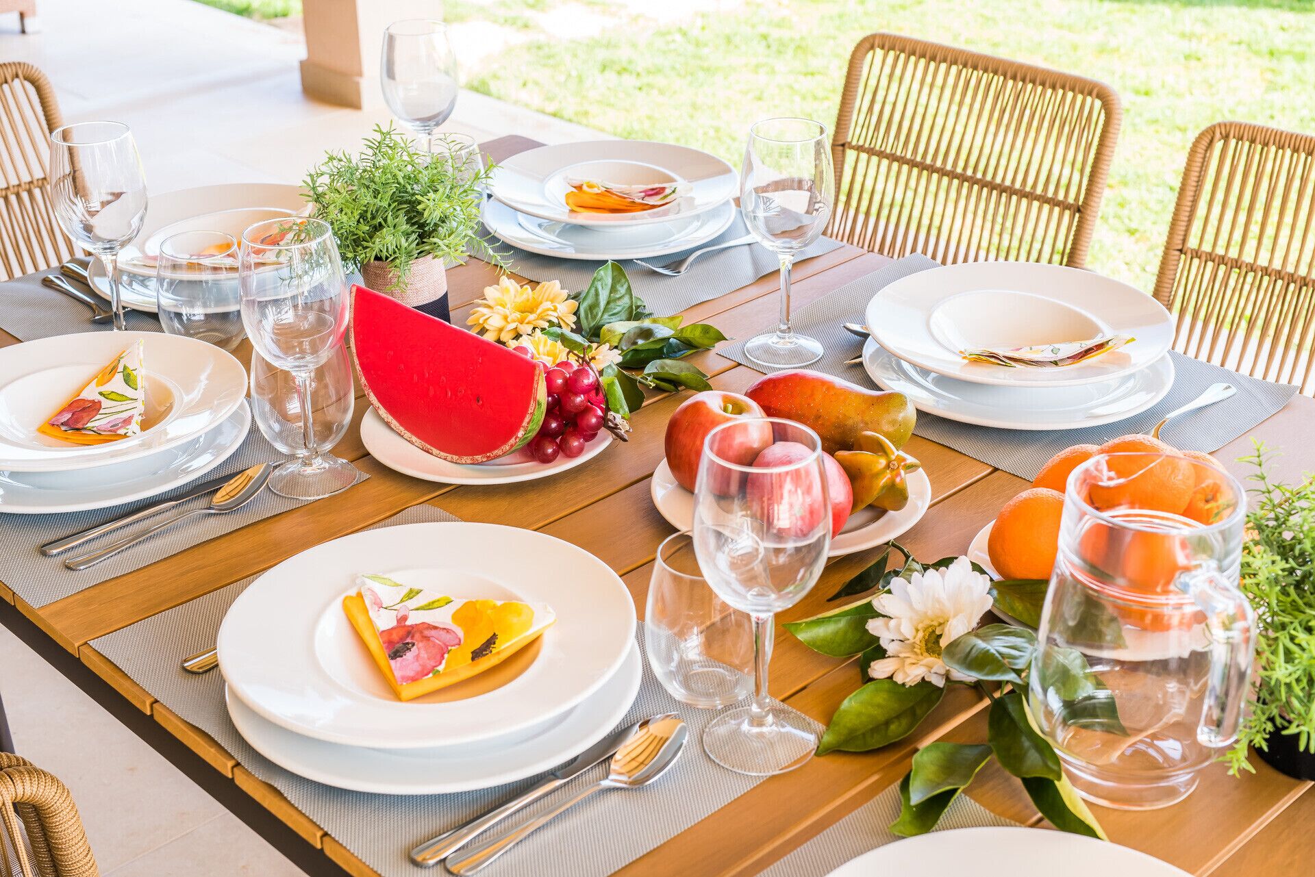 A table set for a meal with plates, cutlery, and glasses.