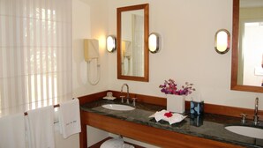 A bathroom with two sinks, a mirror, a telephone, and a vase with flowers. - Armor (1/3 Rooms) Luxury villa (Pointe Milou - Montjean)