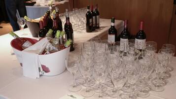 A table with wine bottles and empty wine glasses, suggesting a wine tasting event.