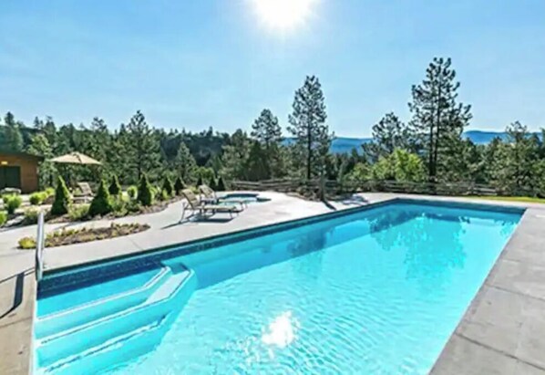 Swimmers can enjoy the pool surrounded by a landscaped garden.