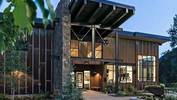 A modern building with a stone facade, large windows, and a covered entrance area. - Basecamp for Your Mountain Adventure (Durango)