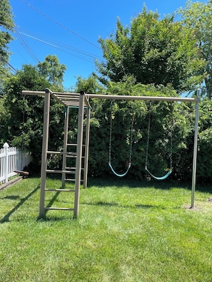 A playground with a swing set and a climbing structure. - Cheerful Home, 3B, 3B, 2 Blocks to the Ocean (Belmar)