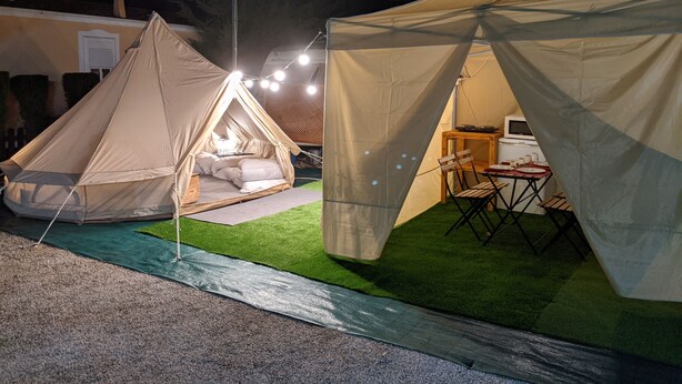 Two tents with a bed inside, a table, and chairs. - camping san javier (San Javier)