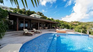 A swimming pool with lounge chairs and a covered patio area. - Kuban (2/3 Rooms) Luxury villa (Colombier)