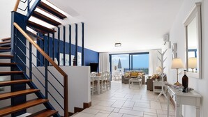 A modern interior with a staircase, dining area, and a view through large windows. - Villa 'Malvasia 22' with Sea View, Heated Pool, Balcony, A/C & Wi-Fi (Puerto Calero)