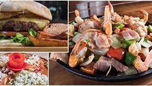 Variedad de platos que incluyen una hamburguesa, ensalada de mariscos y un postre con una rosa.