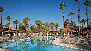 A pool area with lounge chairs and palm trees. - Marriott's Desert Springs Villas II Resort (Palm Desert)