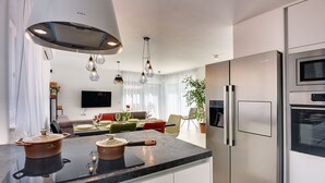 A modern kitchen with a central island, stainless steel appliances, and pendant lighting. - Modern villa with private pool, sun terrace only 2 km from the beach (Medulin)