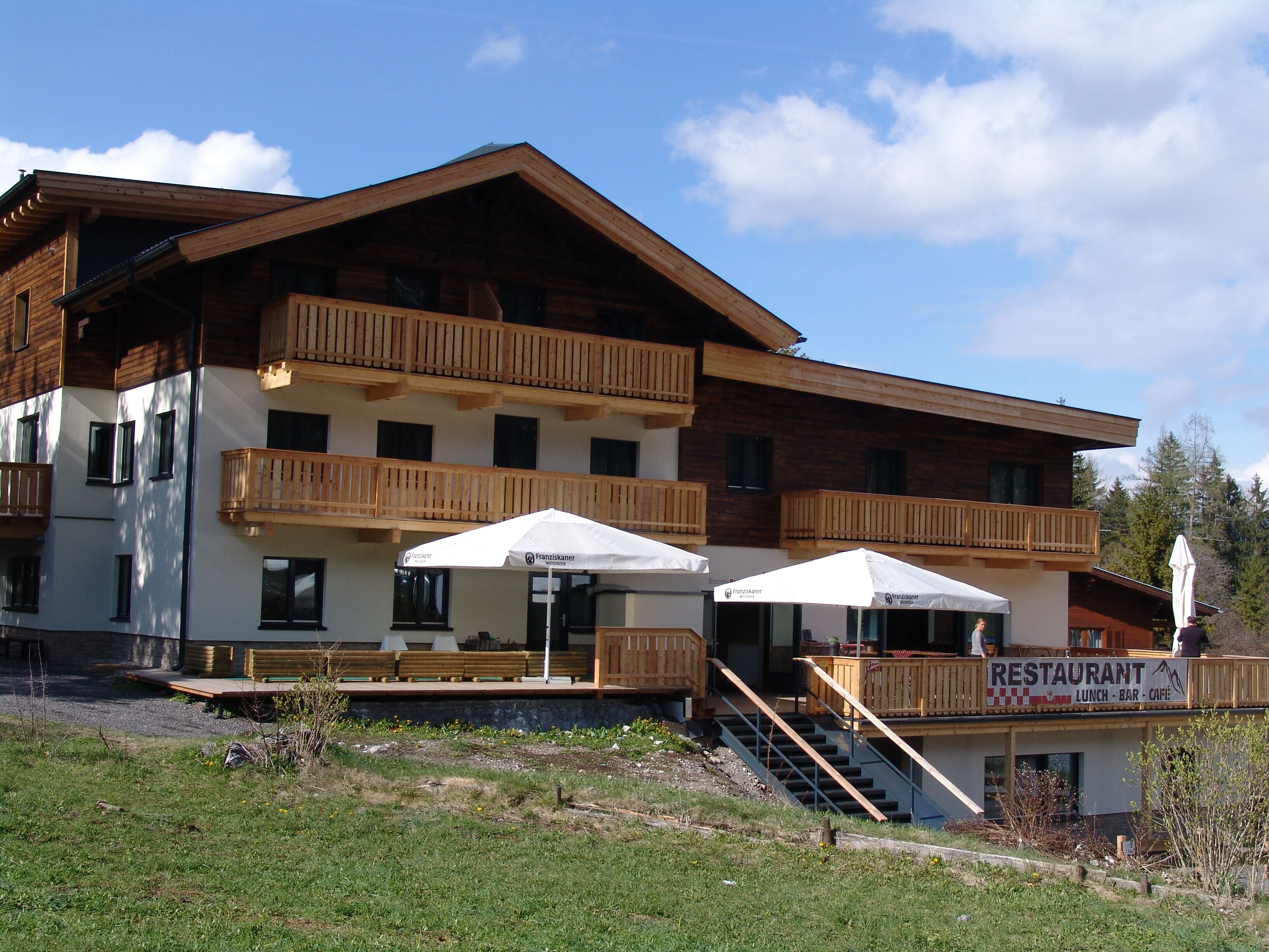 A multi-story building with wooden balconies and a restaurant sign.
