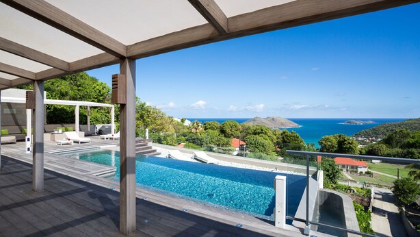 A pool area with a view of the ocean and hills. - The One (1/3 Rooms) Luxury villa (Colombier)