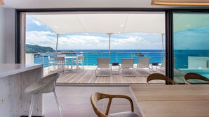 A deck with a view of the ocean, featuring lounge chairs and a table. - Passage (1/2 Rooms) Luxury villa (Gustavia)