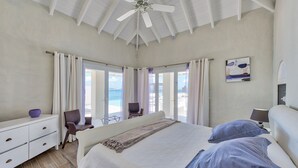 A bedroom with a bed, a dresser, a chair, and a ceiling fan. - Mirabelle (3/5 Rooms) (Terres Basses)
