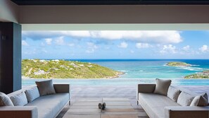 A modern outdoor seating area with a view of a tropical coastline. - Epicure (1/7 Rooms) Luxury villa (Mont Jean)