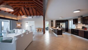 A spacious living area with a sofa, dining table, and kitchen area with modern appliances. - Bellevue (2/5 Rooms) Luxury villa (Marigot)