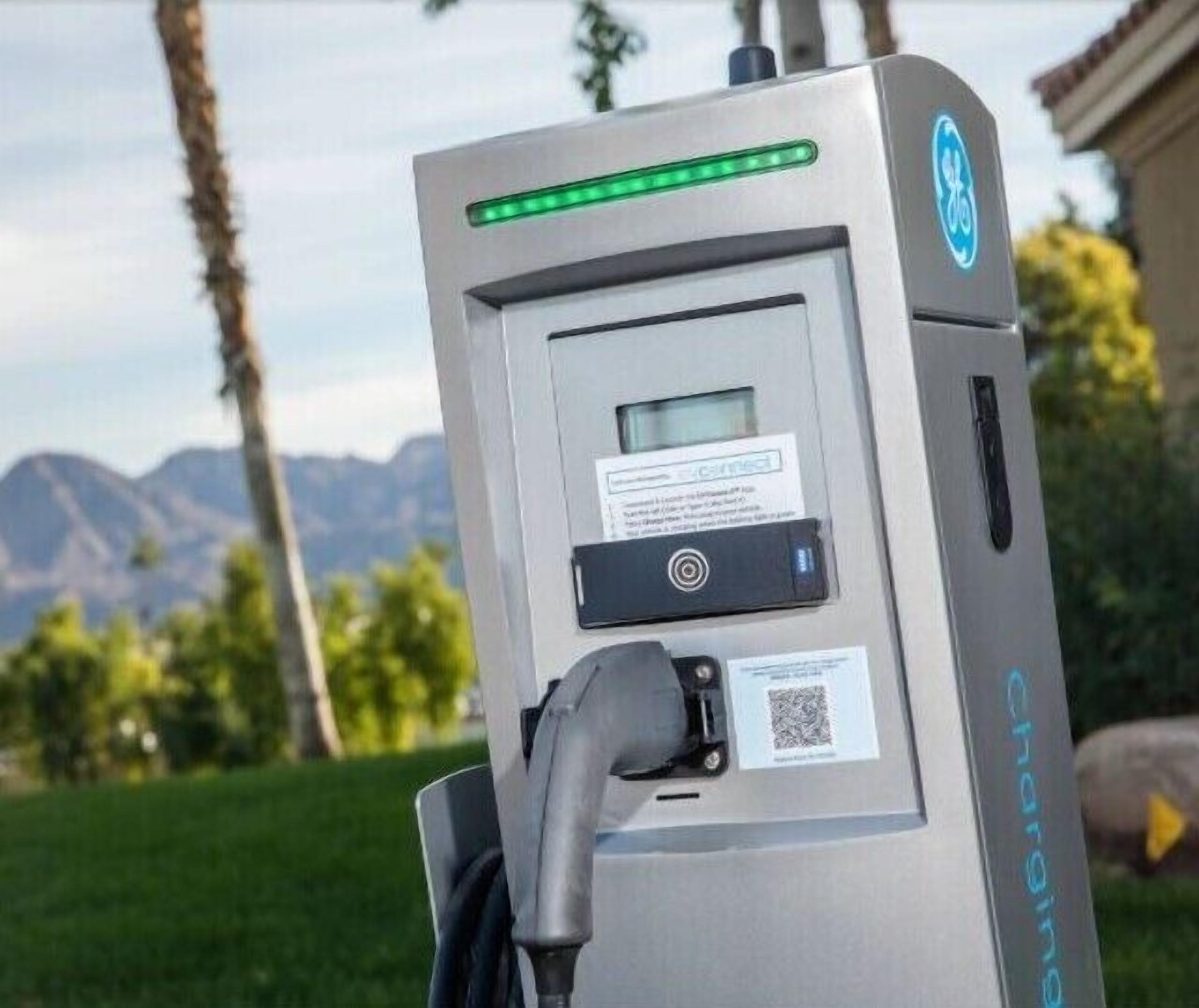 A portable electric vehicle charging station with a digital display, charging cable, and QR code.