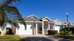 A residential house with a garage, a covered porch, and a street lamp. - Palm Cove Paradise (Panama City Beach)