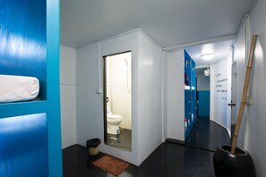 A modern bathroom with a toilet, a shower, and a towel rack. - Oasis Capsules - Hostel (Siem Reap)