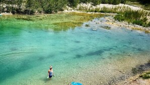 A clear river with people and inflatable rafts.