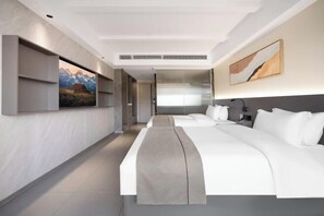 A modern hotel room with a large bed, a bedside table, a nightstand, and a painting on the wall. - Xiang Shan Hotel (Zhong County)