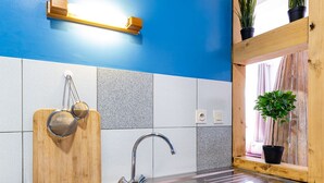 A kitchen with a double stainless steel sink, wooden cutting board, and potted plants. - ❤ LE COCON ❤ Centre Historique ➡ STUDIO TOUT INCLUS ★ (Strasbourg)