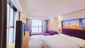 A hotel room with a bed, a desk, a chair, a TV, and a large window.
