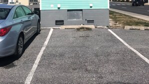 A small building labeled "LAUNDROMAT" with a blue exterior and a red 'K' on the roof.