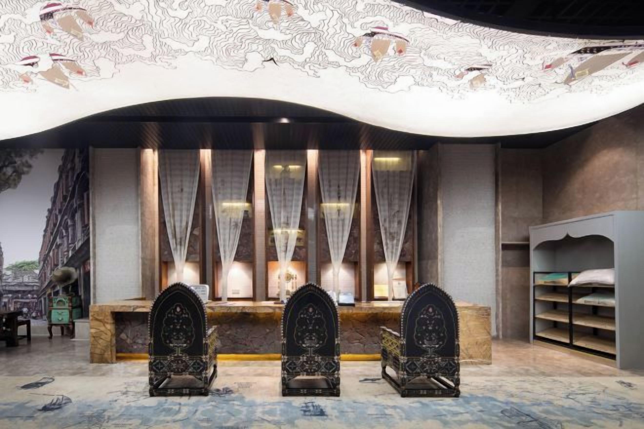 A room with a reception desk, two ornate chairs, a patterned carpet, and a decorative ceiling.