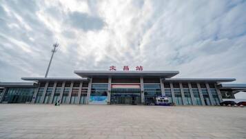 A large building with a flat roof and a sign above the entrance.