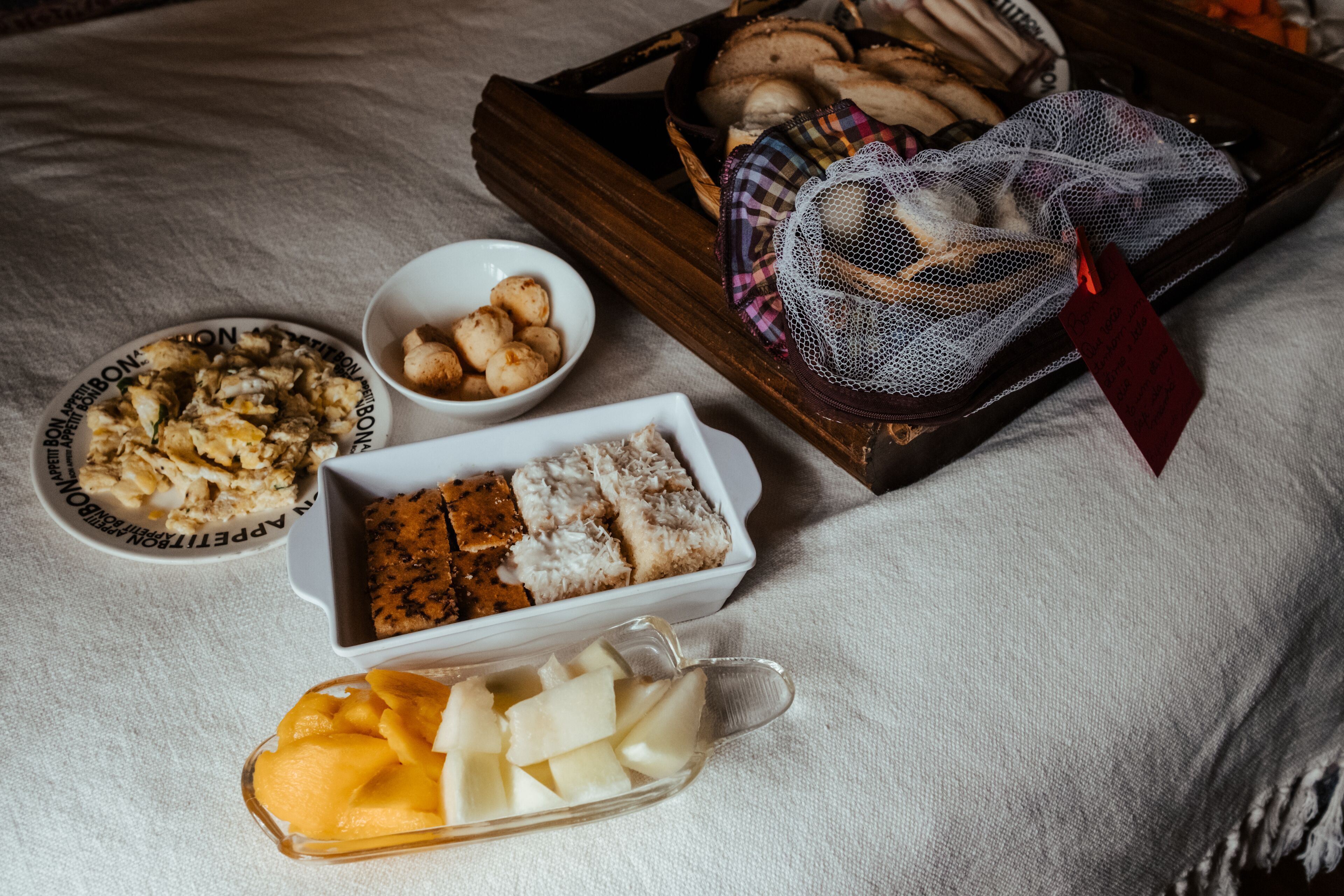 A variety of food items including bread, cheese, and fruits on a table.