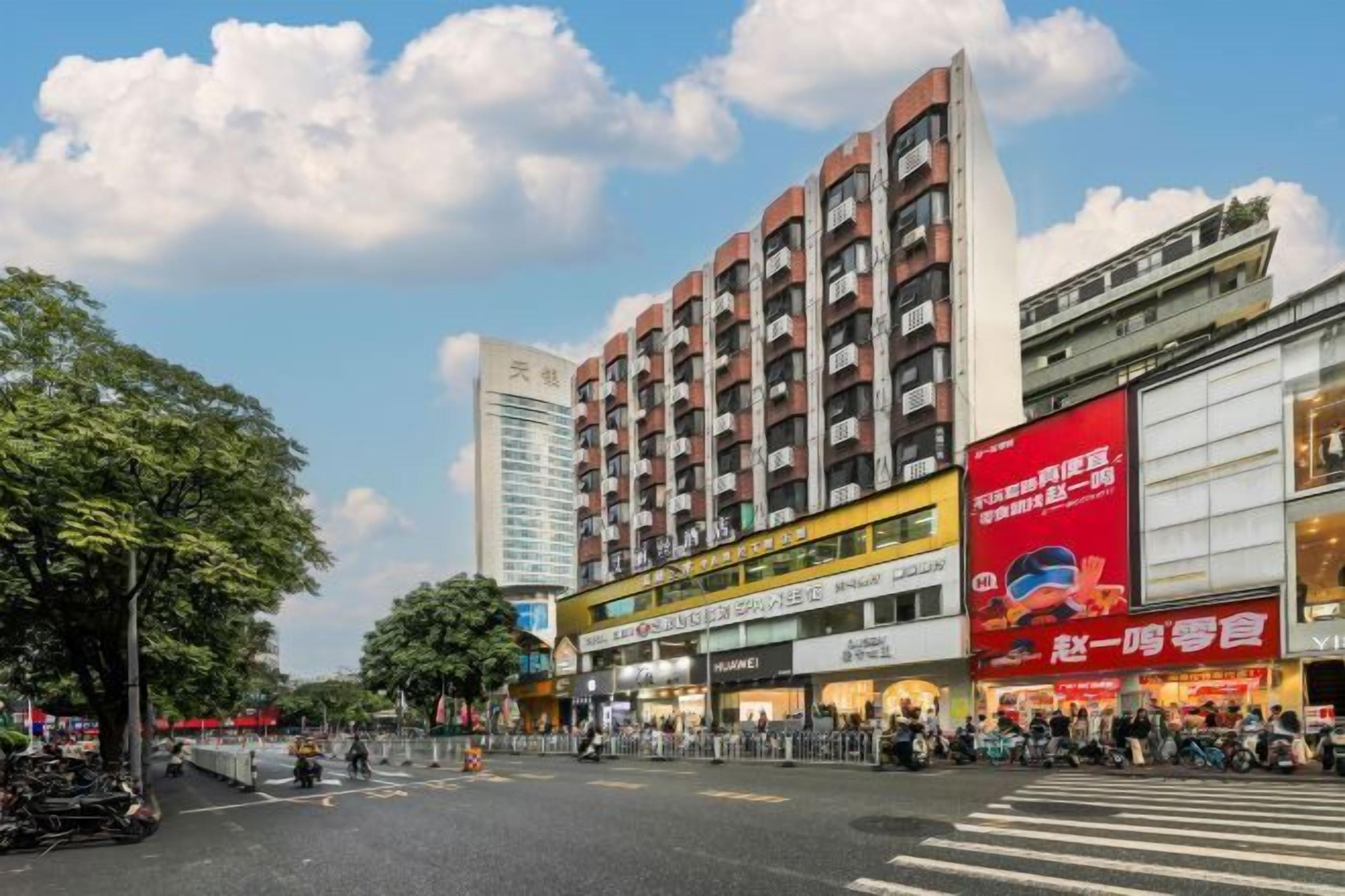 A multi-story building with commercial spaces on the ground floor, including a visible storefront with a red sign.
