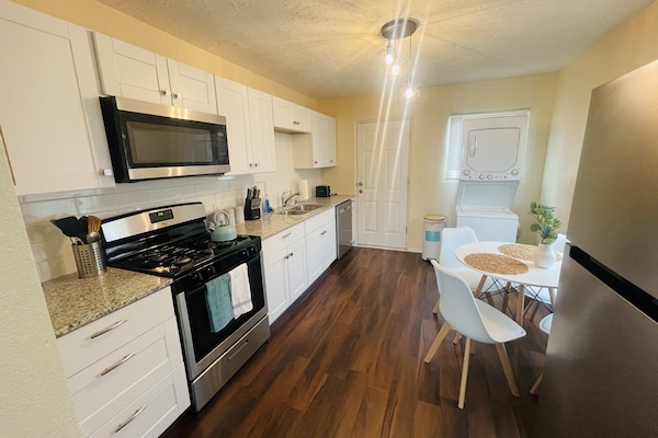 Fully stocked kitchen with washer and dryer.